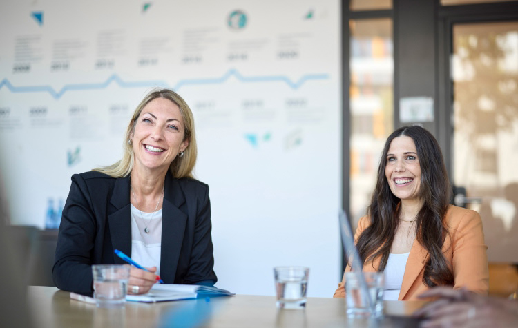 Two colleagues are talking to a person in front of them.