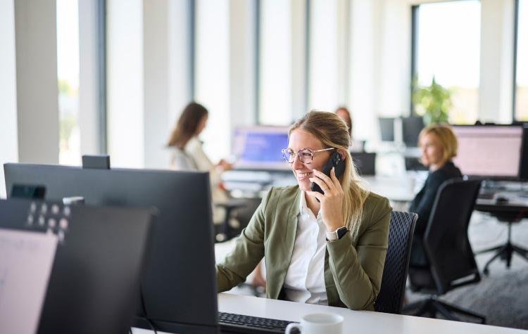 Employee talking on her mobile phone in the office